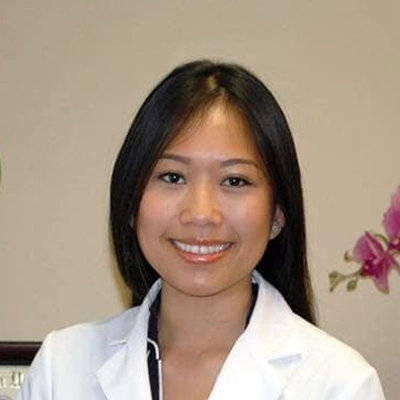 Dentist Lien Kim Ho Smiling In Lab Coat